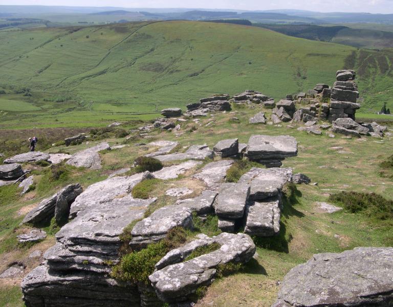 Grimspound, a late Bronze Age settlement, rock circles surrounded by a low stone wall.
