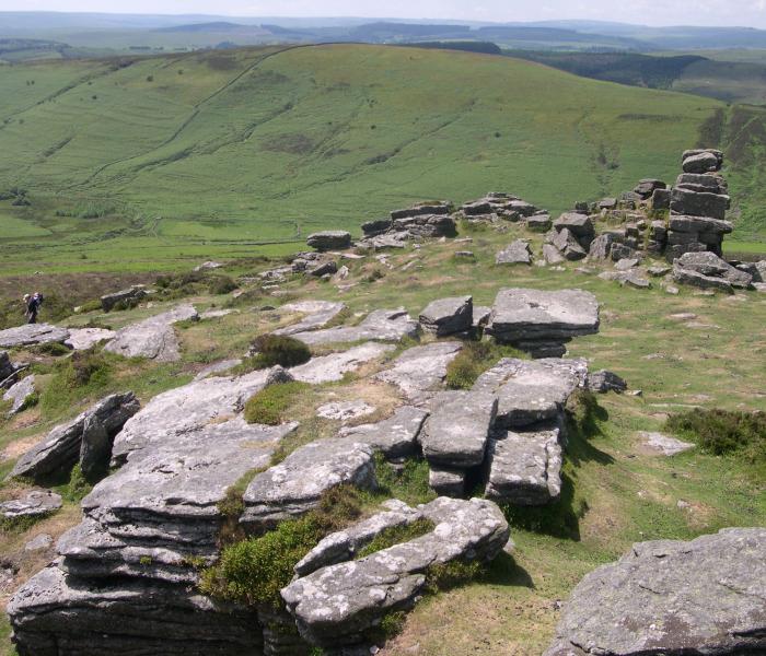 Grimspound, a late Bronze Age settlement, rock circles surrounded by a low stone wall.
