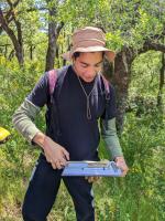 Sonoma State student measuring a piece of concrete during surface survey in 2023.