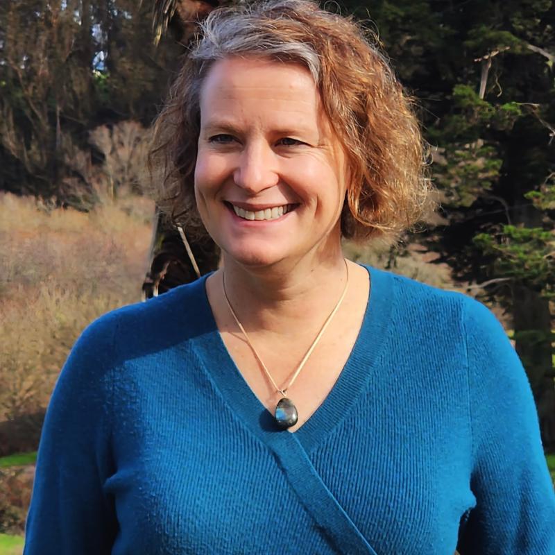 Alexis Boutin wearing teal sweater and smiling