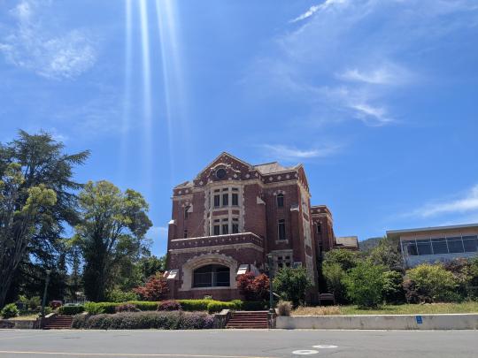 Administration Building at the Sonoma Developmental Center. This is a tall red-brick building that is currently out of use and fenced off. Photo was taken in 2022.